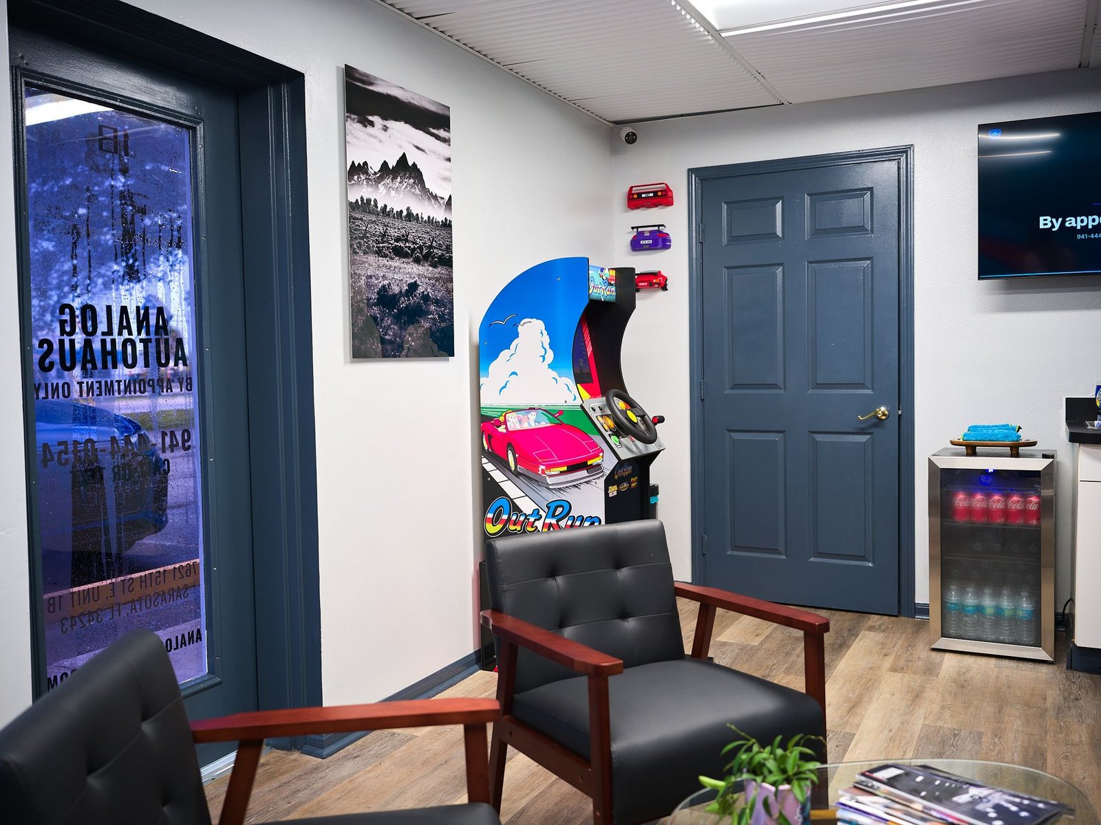 Entrance to the Analog Autohaus Office & Customer Lounge with by-appointment door graphics and Out Run arcade, Sarasota FL